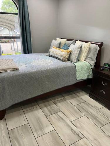 a bed with pillows on it in a bedroom at Willow Ridge Cove in West Monroe