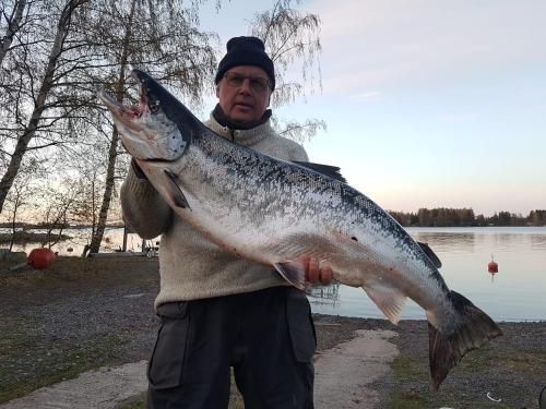 a man holding a fish in his hand at Holiday Village Anttoora - Anttooran Lomakylä in Pori