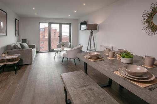a living room with a table and a couch at Dockside Aparthotel, Best Western Signature Collection in Liverpool