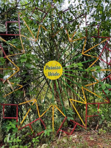 a yellow sign that says pesticide uptake on a fence at Paraiso Verde in Chijoú