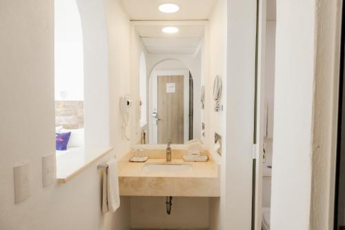 a bathroom with a sink and a mirror at Hotel Villa Varadero in Nuevo Vallarta 