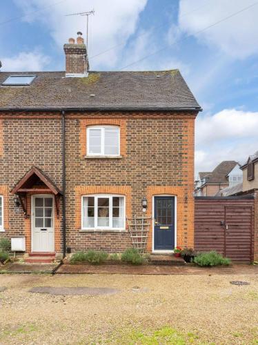 a brick house with a blue door at Quaint 3 bed Cottage in central Dorking with parking in Dorking
