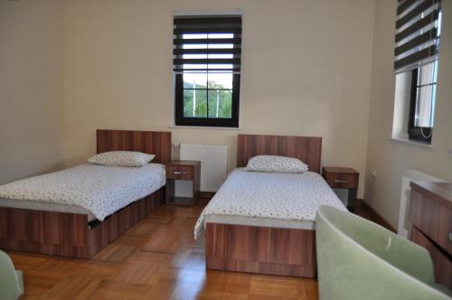 a bedroom with two beds and a window at Apartments Divanhana 1 in Kiseljak