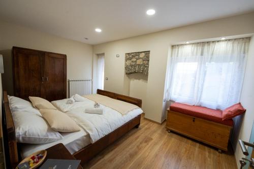 a bedroom with a large bed and a window at 4 TeTE in Vrhpolje