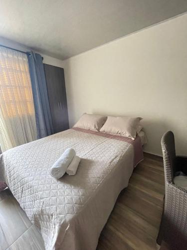 a bedroom with a bed with two towels on it at Apartaestudio #3 in El Boquerón