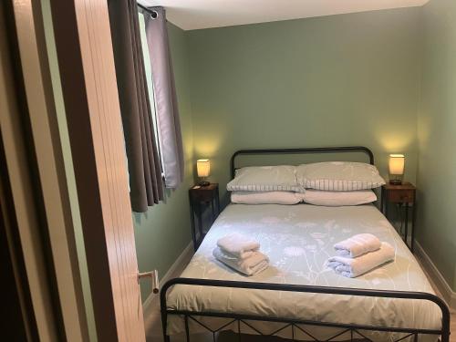 a small bedroom with a bed with towels on it at Tumbledown Hotel in Shrewsbury