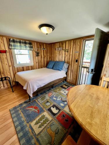 a small room with a bed and a table at Hidden Lake Campground and Resort in Hot Springs