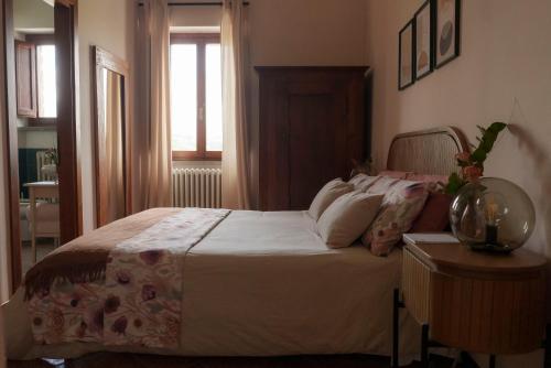 a bedroom with a large bed and a window at Relais di campagna la polledrara in Paliano