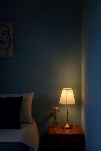 a bedroom with a bed and a table with a lamp at Relais di campagna la polledrara in Paliano