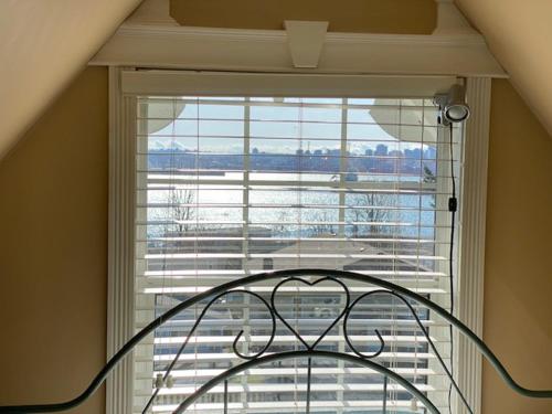 a large window with a view of a building at Ocean Breeze Executive Bed and Breakfast in North Vancouver