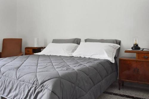 a bedroom with a large bed with white pillows at 19gradini in Putignano