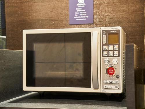 a microwave oven sitting on a shelf in a store at APA Hotel Takaoka Marunouchi in Takaoka