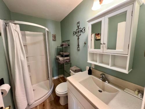 a bathroom with a sink and a shower and a toilet at Hidden Lake Campground and Resort in Hot Springs