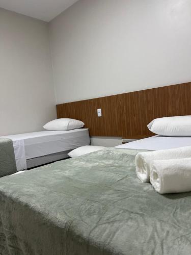 two beds in a hotel room with two beds at pousada praia bela japaratinga in Japaratinga