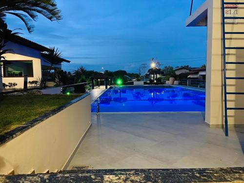 a large swimming pool at night in a house at Hotel Pousada Canoa Quebrada in Canoa Quebrada