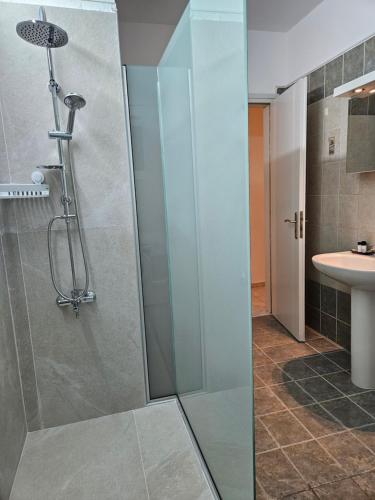 a shower with a glass door in a bathroom at Poppis Home in Ierápetra