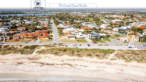 an aerial view of a coastal sand beach with houses at Coastal Sunset Paradise! Beach front & Ocean Views in Rockingham