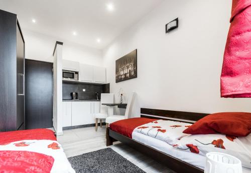 a bedroom with two beds and a desk in it at Hotel Apartments Benešova 6 in Kutná Hora
