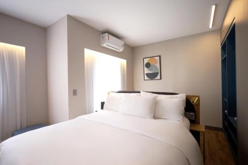Ein Bett oder Betten in einem Zimmer der Unterkunft Clarion Faria Lima