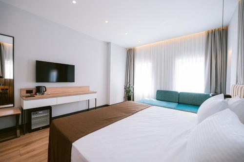a hotel room with a large bed and a television at TRIBUTE Hotel in Shkodër