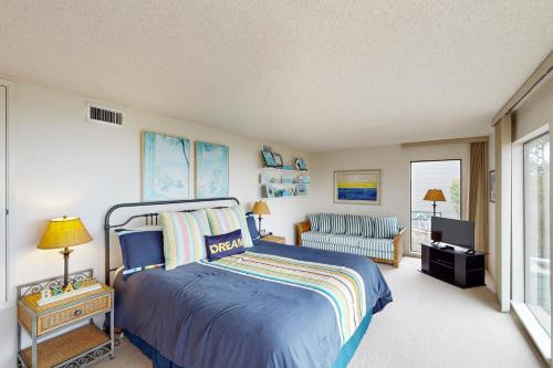 a bedroom with a bed and a couch and a television at Sea Way Dreams in Bodega Bay