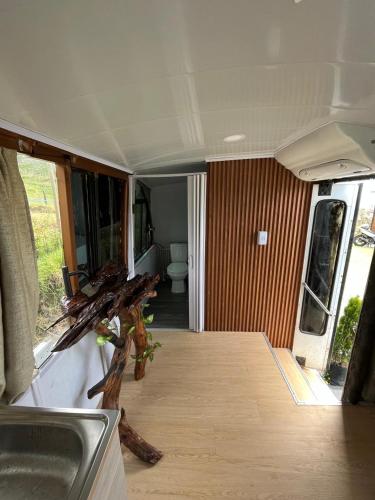 a van with a sink and a toilet in a room at Sky Bus in Bello
