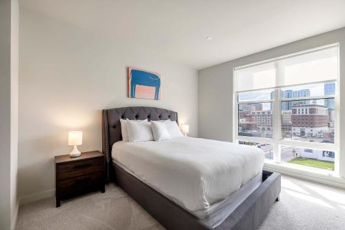 a bedroom with a large bed and a window at New Luxury Apt Downtown with Pool in Stamford