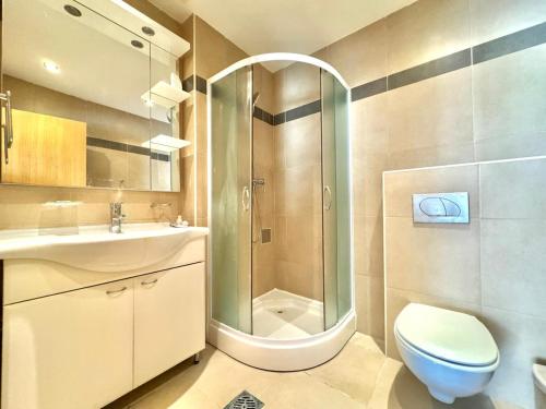 a bathroom with a shower and a toilet and a sink at Sunset Poolside Retreat BlueH in Budva