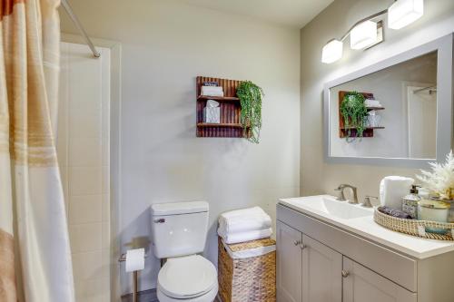 a bathroom with a toilet and a sink and a mirror at Centrally Located Yuma Retreat with Fenced Patio in Yuma