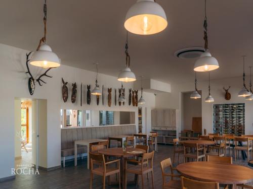a dining room with tables and chairs and lights at Herdade da Rocha - Boutique Lodge in Crato