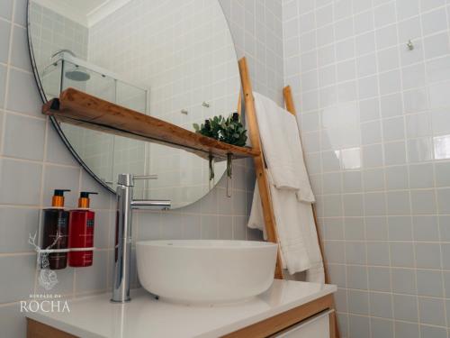 a bathroom with a mirror and a sink at Herdade da Rocha - Boutique Lodge in Crato