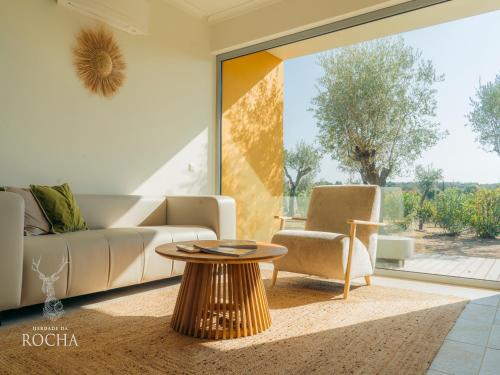 a living room with a couch and a table at Herdade da Rocha - Boutique Lodge in Crato