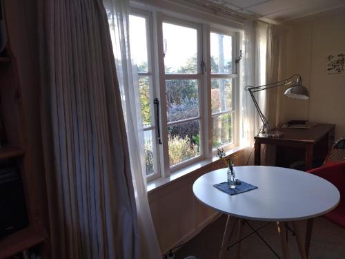 a room with a table and a large window at Waipapa - The Heart of the Harbour in Diamond Harbour