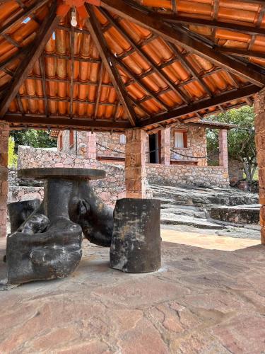 a statue of an elephant sitting next to a table at Recanto Bela Vista Igatu in Igatu
