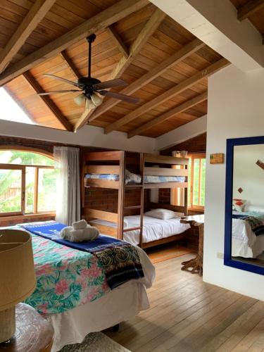 a bedroom with bunk beds and a ceiling fan at La Casa del Rio B&B in Puyo