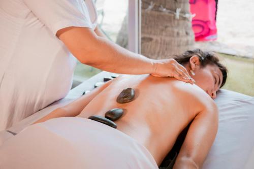 a woman getting a massage from a therapist at Hotel Villa Varadero in Nuevo Vallarta 