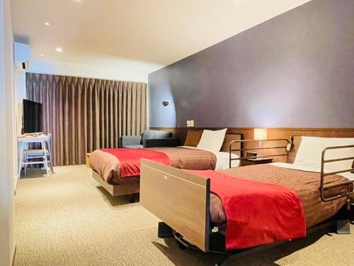 a hotel room with two beds and a television at Seaside house & Terrace SEAGULL - Vacation STAY 80511v in Towa