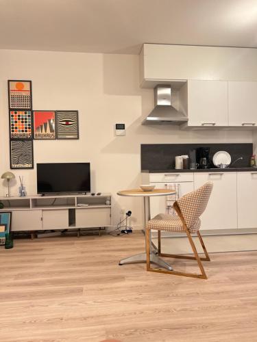 a kitchen with a table and a chair in a room at visit Brussels city in Brussels