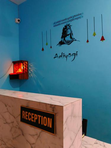 a sign on a wall that says reception at Grihalaxmi Paying Guest House in Varanasi