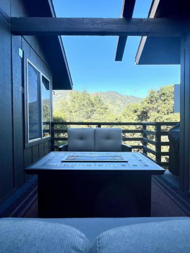 a room with a bed and a balcony with a view at Hidden Valley Inn in Carmel Valley