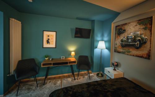 a bedroom with a bed and a desk and a painting of a car at AMADA CITY CENTER in Iaşi