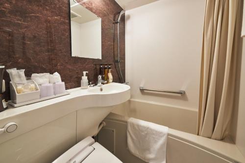 a bathroom with a sink and a toilet and a mirror at FIVE HOTEL OSAKA - Vacation STAY 72912v in Osaka