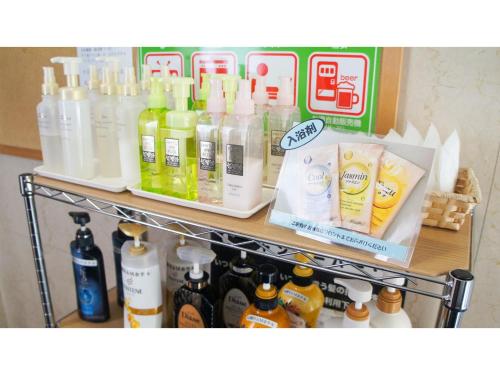 a shelf filled with lots of bottles of liquid at Takatsuki W&M Hotel - Vacation STAY 02642v in Takatuki