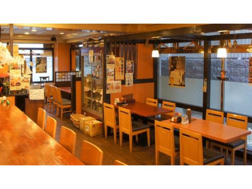a dining room with wooden tables and chairs at Takatsuki W&M Hotel - Vacation STAY 02642v in Takatuki