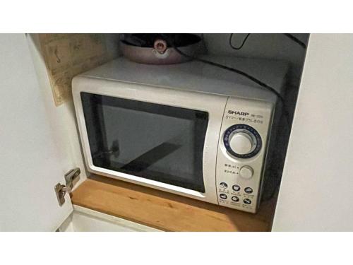 a silver microwave sitting on top of a counter at Takatsuki W&M Hotel - Vacation STAY 02654v in Takatuki