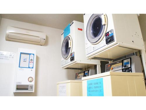 a room with two washing machines and a air conditioner at Takatsuki W&M Hotel - Vacation STAY 02648v in Takatuki