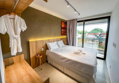 ein kleines Schlafzimmer mit einem Bett und einem Fenster in der Unterkunft Milagres Hospedagens - Casa Praia & Capela in São Miguel dos Milagres