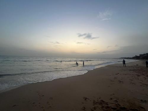 a group of people playing in the water at the beach at Villa Vista in Toubab Dialaw