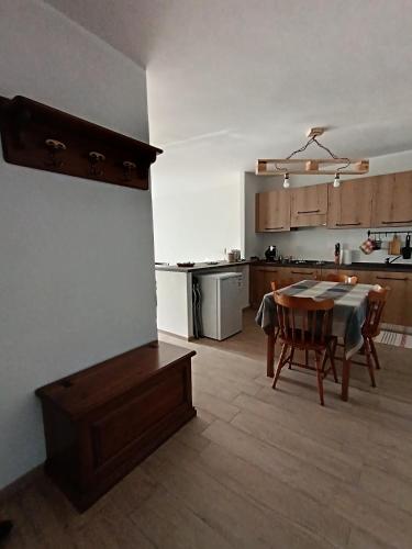 a kitchen and dining room with a table in a room at Come una barca nel bosco in Villar Perosa