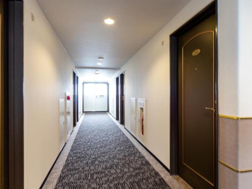 a corridor of a hallway with a door and a carpet at Sun Hotel Kokubu - Vacation STAY 62468v in Kirishima